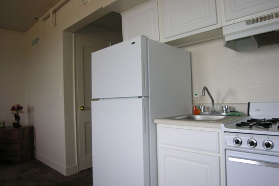 Fairmont Apartments Model white Kitchen with kitchen appliances